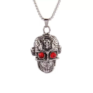 Punk skull necklace with red stone eyes on a vintage silver pendant and metal chain