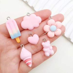 Cute pink resin DIY pendants featuring ice cream, cloud, and heart shapes in a palm