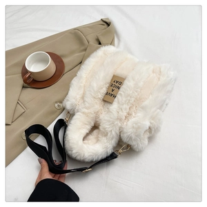 Close-up of white plush tote bag with Have a Nice Day tag and black wide strap