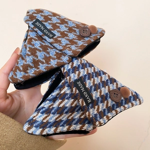 Close-up of knit houndstooth hair claw clips with buttons and hand made fabric labels