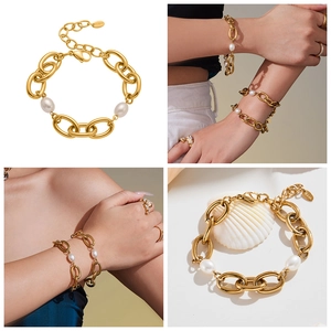 Detail of 18k gold plated stainless steel chain bracelet with two white oval pearls