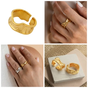 Detailed close-up of chunky gold and silver lava texture rings with irregular wide bands