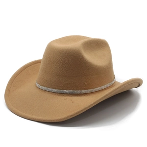 Detail of camel western hat with sparkling silver rhinestone band on white background
