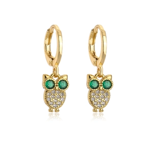 Detail of 18K gold plated owl earrings featuring green stones and micro-set cubic zirconia