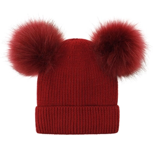 Detail of dark red knit beanie with dual fluffy faux fur pom poms and ribbed texture