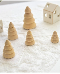 Detailed close-up of natural wooden mini Christmas trees in a snowy festive scene