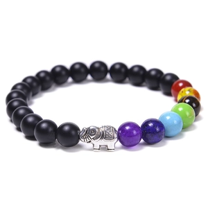 Close-up of seven chakra beaded bracelet featuring matte black stones and silver elephant