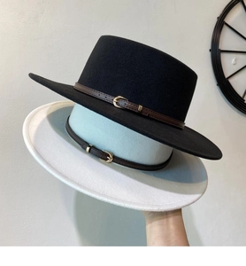 Detail of wool fedora hats with leather buckle bands in black and light blue colors
