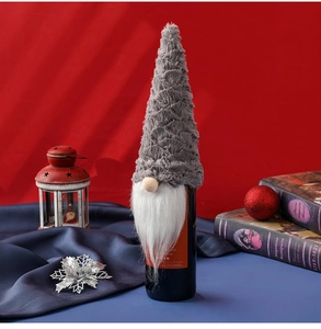 Detail of Christmas gnome wine bottle cover featuring grey plush hat and white beard