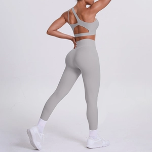 Close-up of light gray two-piece yoga set with open back sports bra and high waist leggings