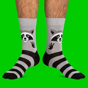 Detail of striped cotton socks featuring a creative raccoon jacquard and paw print design