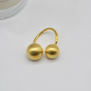 Minimalist gold frosted ball open ring with brushed metal texture on white background