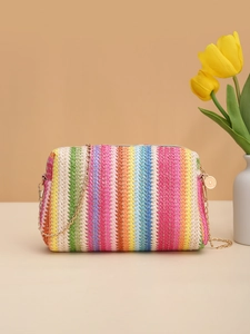Detailed shot of rainbow straw woven camera bag with gold chain strap and metal buckle