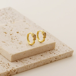 Detailed close-up of S925 hallmark on gold plated rose flower earrings with diamonds