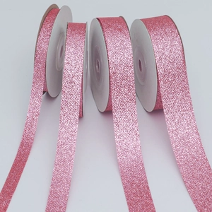 Detail of pink glitter ribbon rolls for gift wrapping and festive DIY decorations
