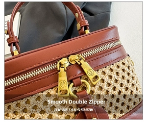 Detailed close-up of smooth gold metal zippers and hand-woven texture on a leather handbag