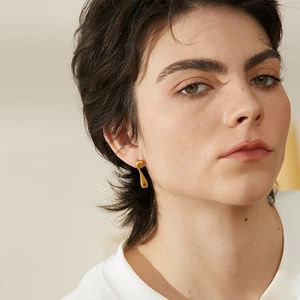 Elegant gold plated asymmetric teardrop earrings on model for a modern minimalist look