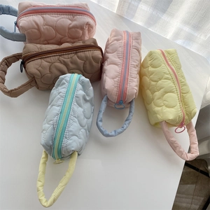 Quilted floral makeup bags in five pastel colors with soft cloud texture and carrying handles