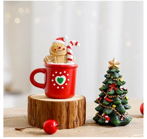 Miniature Christmas resin figurine with gingerbread man in red cup on a rustic wood base