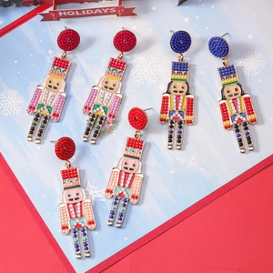 Detail showing beaded nutcracker earrings with enamel painting and sparkling rhinestones