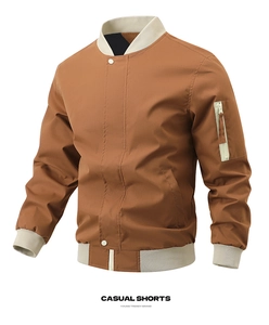 Detail of a brown bomber jacket with ribbed cuffs and a utility zipper pocket on the sleeve