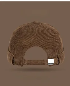 Detail view of corduroy docker cap with adjustable metal buckle on back strap