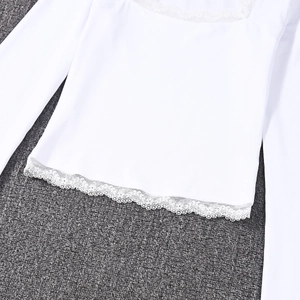 Detailed close-up of delicate white lace hem on a slim-fit long-sleeve blouse top