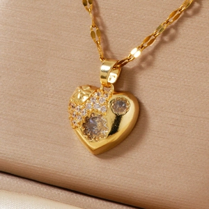 Close-up of golden heart pendant with shimmering cubic zirconia on satin jewelry box