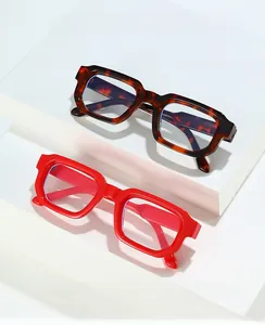 Detail of tortoise and red thick-frame blue light blocking glasses on stone pedestals