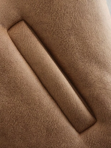 Macro shot of dark brown faux suede fabric showing rich texture and stitching details