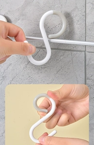 Detail of flexible S-hooks in white and gray showing durability and bending test