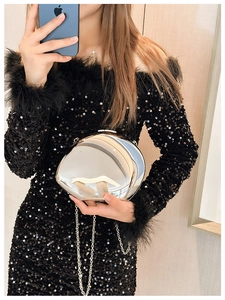 Polished silver sphere metal clutch bag with a delicate chain strap detail