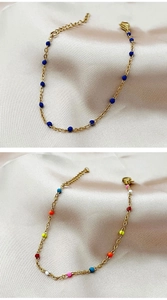 Detail of bohemian gold link bracelets with navy blue and colorful enamel beads on silk