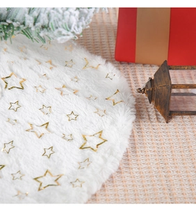 Close-up of white plush Christmas tree skirt with golden star sequins and festive decor