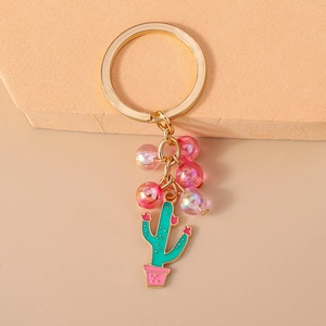 Close-up of beaded cactus keychain with pink flower pot and colorful charms