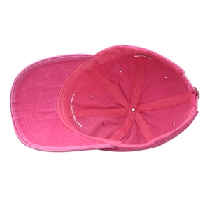 Detail of pink washed cotton baseball cap interior showing 6-panel structure and metal buckle