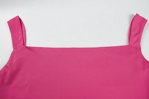 Detail of square neckline and wide straps on a vibrant rose red backless dress