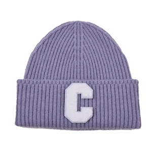 Macro shot of purple ribbed knit beanie with white letter C patch embroidery