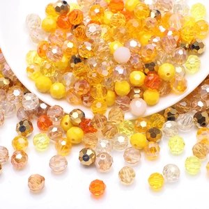 Macro shot of faceted yellow and champagne crystal glass beads spilling from a white bowl