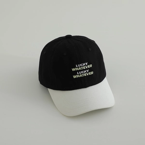 Close-up of Lucky Whatever embroidery and contrast stitching on cotton baseball cap