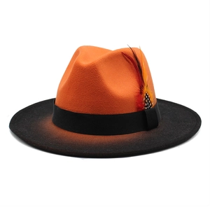 Stylish orange and black gradient wool fedora hat featuring a decorative feather accent