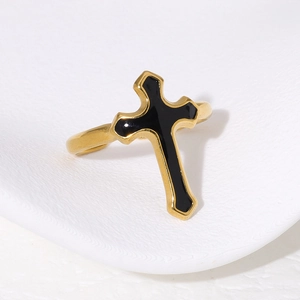 Vintage gold stainless steel cross ring with black enamel inlay on white texture