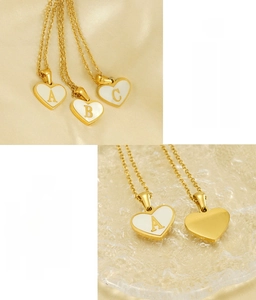 Macro detail of heart-shaped shell pendant showing gold-plated stainless steel texture