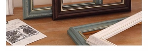 Detail of vintage European picture frames with bead edges and distressed wood texture