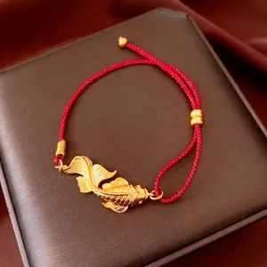 Vintage koi fish pendant bracelet with red woven cord and golden metal accents