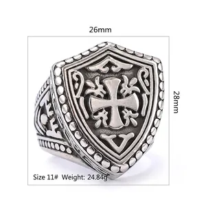 Vintage stainless steel cross shield ring with intricate carvings and size measurements