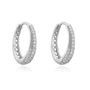 Detailed macro view of silver hollow U-shaped earrings with micro-pave white zircon stones