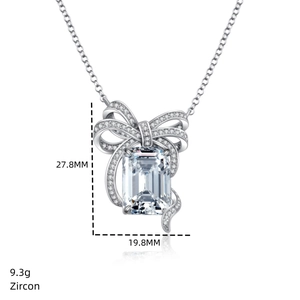 Macro detail of silver bow pendant with dimensions 27.8mm by 19.8mm and zircon stone