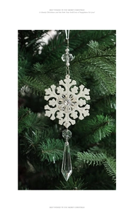 Detail of glitter snowflake ornament with crystal beads on a Christmas tree branch