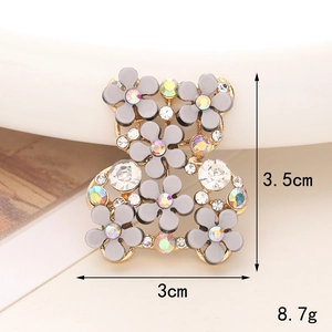 Detailed view of a bear shoe charm with grey flowers and rhinestones measuring 3.5cm by 3cm